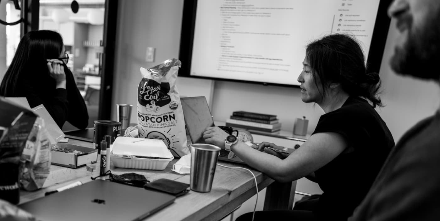 Moment team member concentrates on coding work on a laptop.